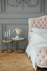 Elegant home or hotel bedroom interior, copy space. Pillows on luxury chesterfield bed, vintage...
