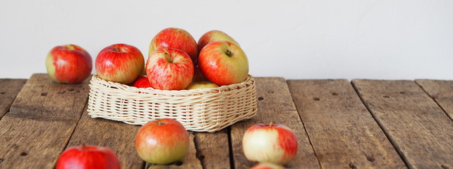 Agricultural apple background. Red early ripe apples on a wooden background.