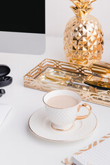 Gold desktop office with cup of coffee  in a white background