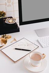 Cup of coffee in a gold desktop office in a white background