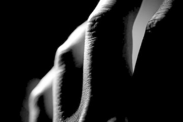 hand fingers close up on a black background