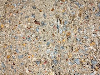 textured background concrete surfaces interspersed with small stones