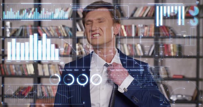 Handsome Businessman is Very Tired of the Huge Amount of Economic Information Presented in the Appearing Charts and Graphs. Slow Motion Business Concept. Businessman Series 4K UHD 4096x2160.