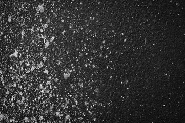 Wall grunge black concrete with light background. Dirty,dust wall concrete blackboard texture and splash white color space for text or abstract background.Soft focus image.