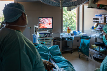 medical team operates on a patient endoscopically in an operating room