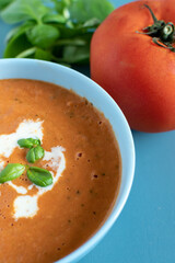 cream of tomato soup with basil leaves 