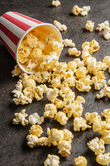 Sweet tasty popcorn in striped paper cup.