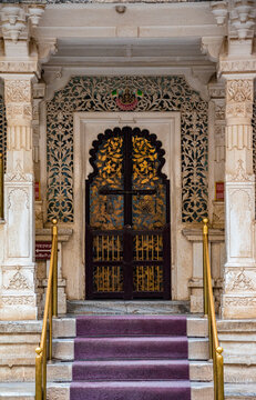 An ornate door with beautiful carving and decoration around.