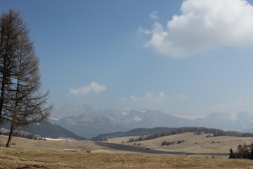 mountain view in late winter with blue sky and melting snow
