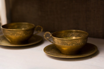 antique tea mugs with copper saucers. Unusual home decor items