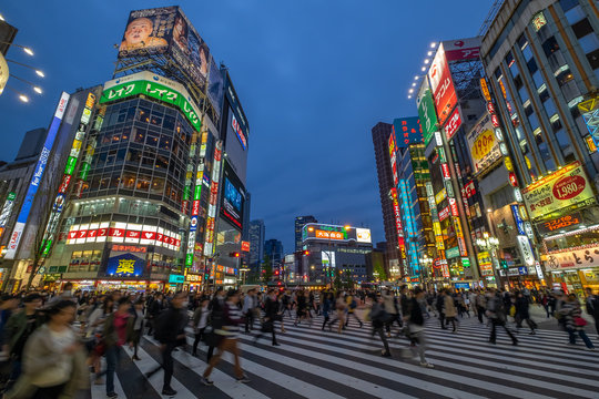 Tokyo, Japan - April 21, 2017: Crowds of people at a busy crossing in Shinjuku at twilight on 21 April 2017 in Tokyo, Japan.