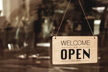 Text sign that says ‘Open’ in cafe or restaurant hang on door at entrance. - Powered by Adobe