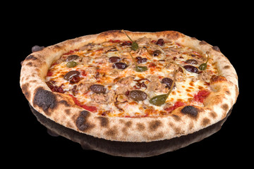 Delicious pizza Tuna with tomatoes, olives, onion and capers, with reflection, isolated on black background