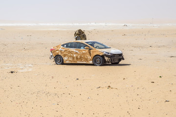Fototapeta na wymiar Abandoned refugee vehicles in the sahara Desert, Chad