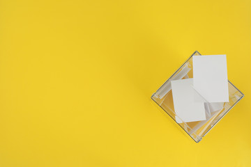 Voting box with bulletins on yellow background, space for text