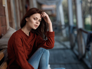 Fototapeta premium woman sitting on bench on terrace at home leisure fresh air lifestyle