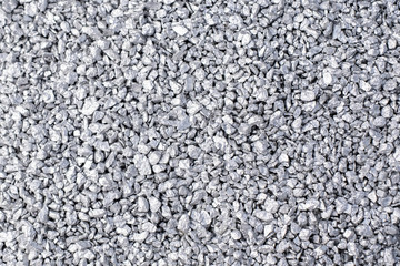 Silver granules. Pile of small silver particles on dark gray background.
