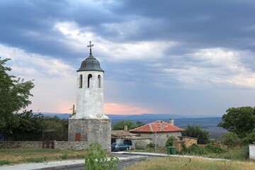 Fototapeta na wymiar Church in the village of Avren (Bulgaria) in the evening at sunset