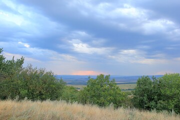 View of the plain from a height in the vicinity of the village of Avren (Bulgaria) at sunset