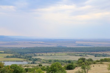 View of the plain from a height in the vicinity of the village of Avren (Bulgaria) at sunset