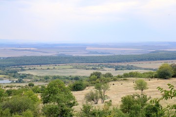 Fototapeta premium View of the plain from a height in the vicinity of the village of Avren (Bulgaria) at sunset