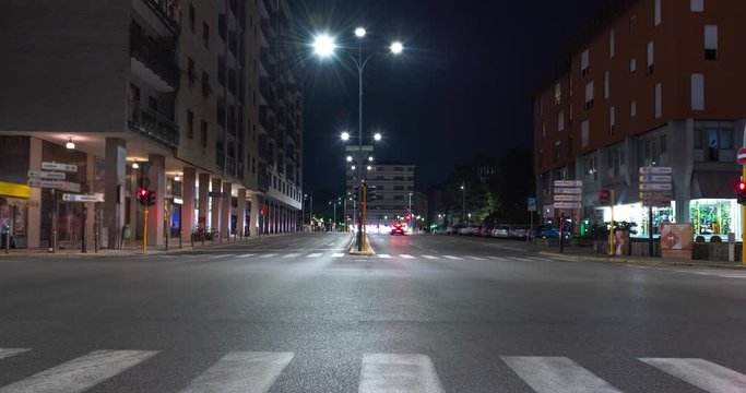 Timelapse view of traffic at an urban night intersection. Urban movement in the Italian city in the evening.Time Lapse.