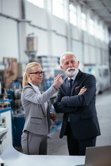 Man and woman discussing work. Colleagues working in factory