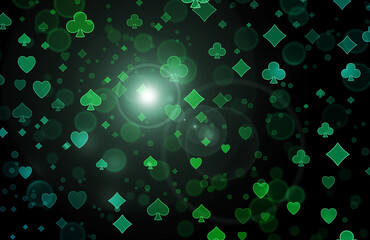 Bright colored blurred bokeh pattern of poker symbols.