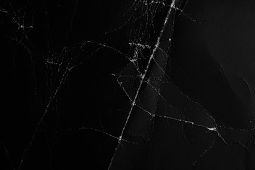 Crumpled and worn surface of dark black paper