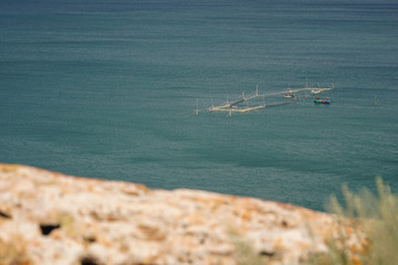 Fishermen by boat near fishing nets