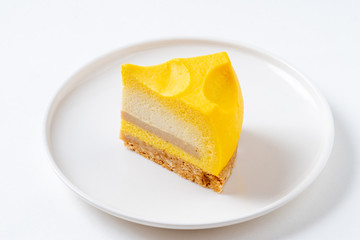 Slice Of Tom & Jerry Cheesecake On White Plate. Closeup View
