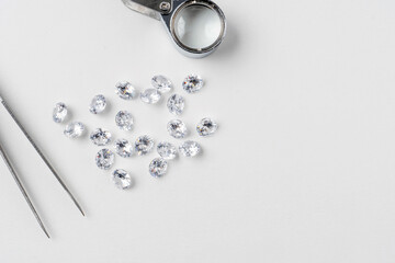 brilliant cut diamond held by tweezers isplated on bwhite background
