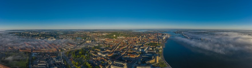 Panoramic aerial view of Aalborg city and Aalborg port in the early morning with fog, Denmark