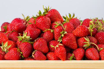Ripe strawberries ready for eating in wooden boxes. Red ripe strawberries closeup. Selective focus. You can use as the background for any of Your project.