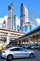 freeway intersection in modern city landscape against downtown skyscrapers skyline background Street view of urban highway transportation infrastructure in Moscow city Russia Vertical photo