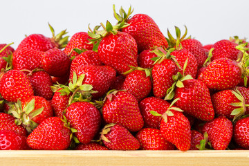 Ripe strawberries ready for eating in wooden boxes. Red ripe strawberries closeup. Selective focus. You can use as the background for any of Your project.