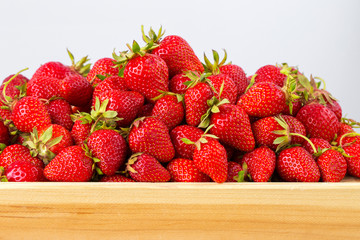 Ripe strawberries ready for eating in wooden boxes. Red ripe strawberries closeup. Selective focus. You can use as the background for any of Your project.