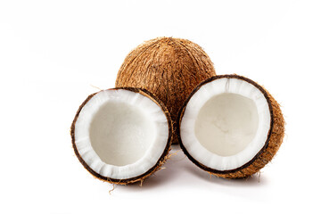 Coconut on a black background. Chopped coconut. Several parts. Stone surface. Fresh coconut. White pulp.