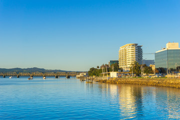 Tauranga waterfront and business district buidlings caught on golden glow of sunrise