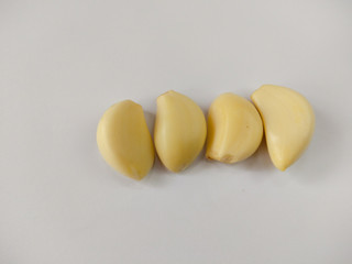 Closeup peeled garlic (Allium sativum) on a white background. garlic as a seasoning for flavoring food