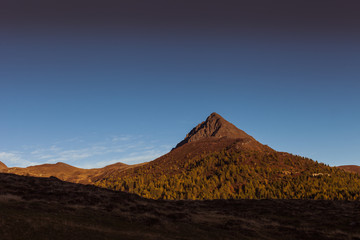 Sunset colors over the top of a volcano-shaped mountain, Col Quaterna, Dolomites, Veneto, Italy. Panorama that inspires peace, tranquility and meditation