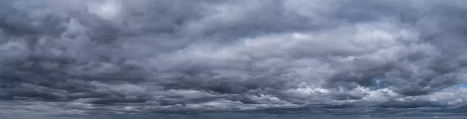 Foto op Plexiglas Panorama of Cumulus fluffy white and dark grey storm clouds against sky background. © Marina Gordejeva