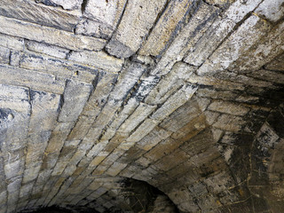 Abstract background of the old wall of black natural stone with cracks and scratches. Landscape...