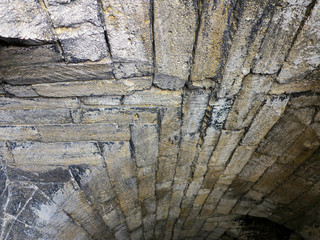 Abstract background of the old wall of black natural stone with cracks and scratches. Landscape...