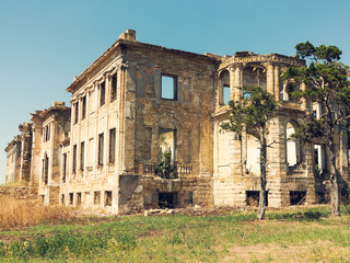 Mystical Interior, ruins of facade of an abandoned ruined building of an ancient castle 18th century. Old ruined walls, corridor with garbage and mud. Ruins Ancient historic building destroyed by war