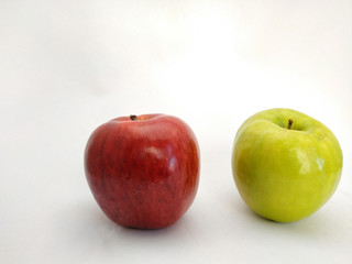 macro view of a red and a green apple on a white background