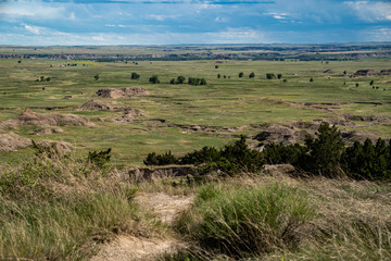 Distant view of badlands rock formations and praire plains of Badlands National Park in South Dakota