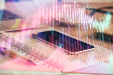 Double exposure of forex chart drawing and cell phone background. Concept of financial trading