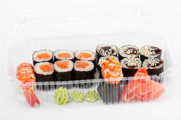 Sushi in plastic container. Sushi delivery. Delicious and creative gourmet cuisine.