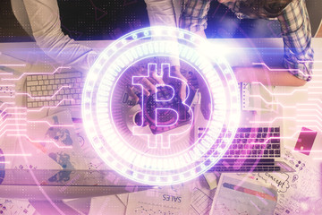 Double exposure of man and woman working together and crypto theme hologram drawing. Computer...